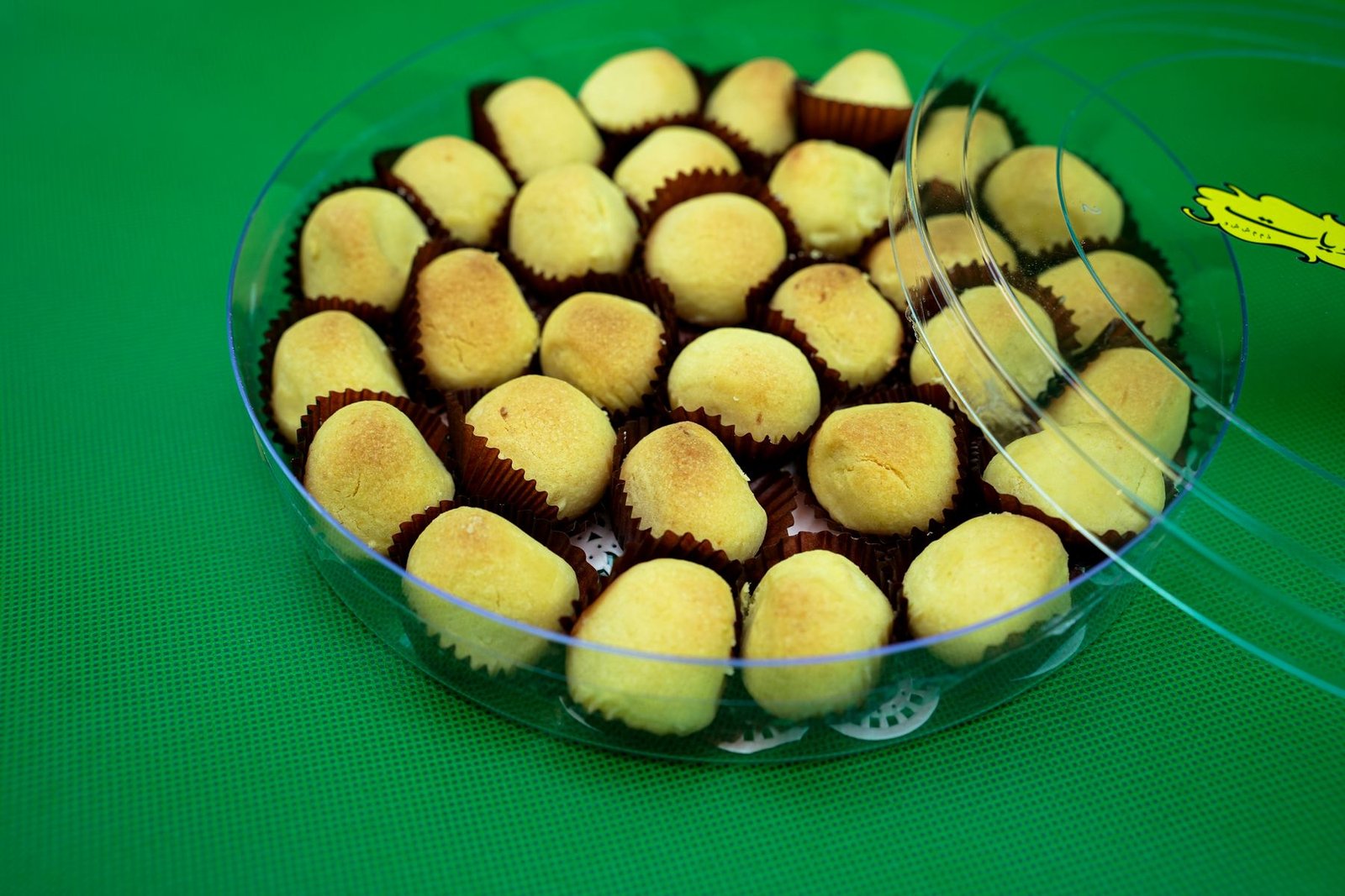 Traditional date and nut sweets arranged in a tin at Al Ward Al Shamali Sweets